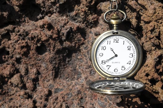 Time Concept Classic Vintage Pocket Clock on the Volcanic Rocks