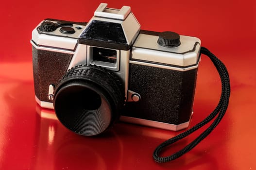 Classic 35mm Plastic Toy Photo Camera on a Colored Background