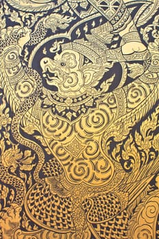 Traditional Thai style art gold painting pattern on the door in Temple Bangkok, Thailand