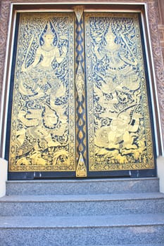 Traditional Thai style art gold painting pattern on the door in Temple Bangkok, Thailand