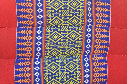 Thai Esan traditional pillows have a specific shape like cube and contain the pure cotton inside. The pillow surface has a specific weaving pattern and gaudy color. Handcraft art.