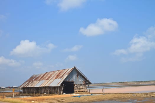 salt in the bamboo basket on the ground near salt pan, Thailand