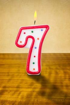Burning birthday candle number 7