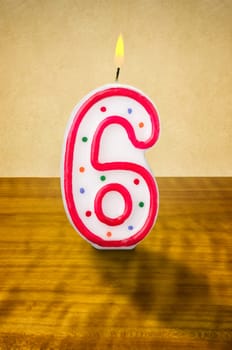 Burning birthday candle number 6