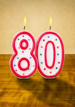 Burning birthday candles number 80