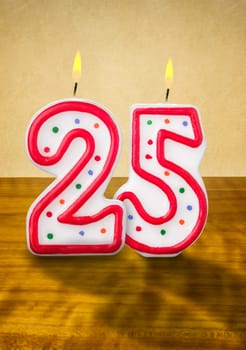 Burning birthday candles number 25