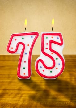 Burning birthday candles number 75