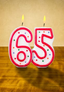 Burning birthday candles number 65