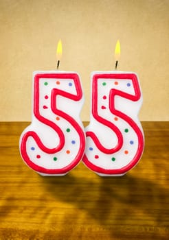 Burning birthday candles number 55
