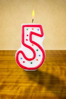 Burning birthday candle number 5