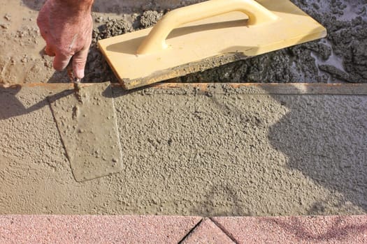Concreting,worker smoothing concrete
