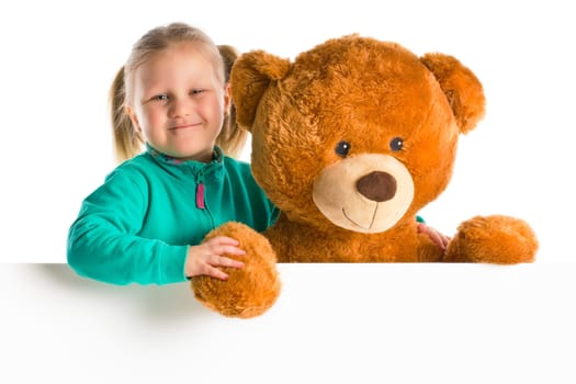 little girl with big teddy bear behind whiteboard