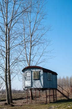 Stilt fisherman bungalow on iron piles in sunny winter day