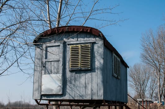 Stilt fisherman bungalow on iron piles in sunny winter day