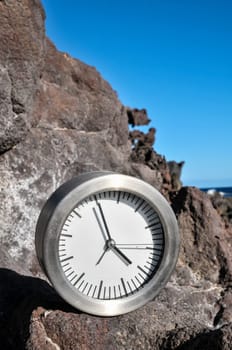 Time Concept Alarm Clock on the Volcanic Rocks