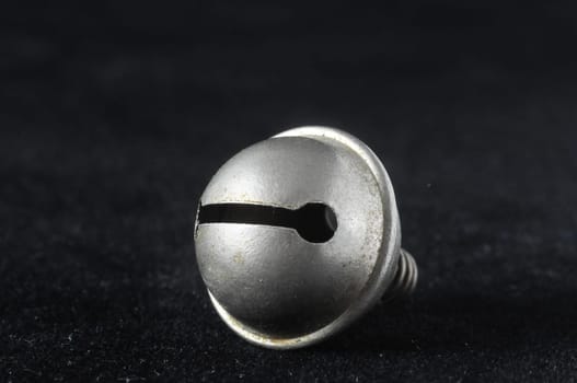 Vintage Small Metal Bell on a Black Background