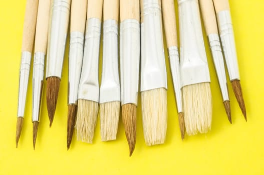 New Wooden Different Paintbrush Set Texture over a Colored Background