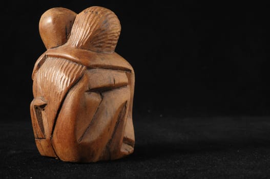Lovers Sculpture made of Wood on a Black Background