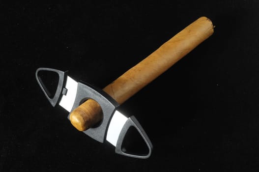 Cuban Brown Havan Cigar and Cutter on a black background