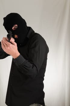 Black Dressed Young Man Holding a Pistol Gun