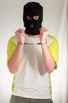 White Dressed Young Man Trapped in Hancduffs
