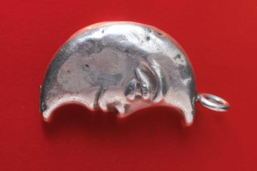 Half Moon Silver Jewel over a Colored Background