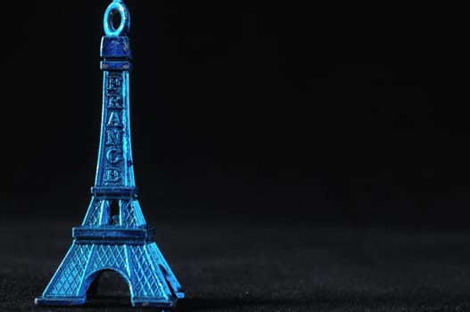 Blue Tour Eiffel Statuette on a Black Background