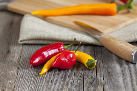 Hot chili peppers on rustic wooden table