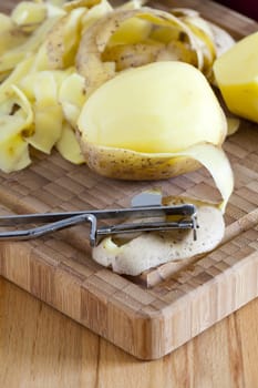 Close-up of potato and potato peeler