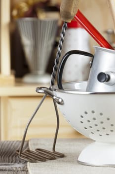 Kitchen utensils in front of a kitchen cabinet
