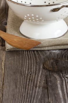 Silk and wooden spoon on rustic table
