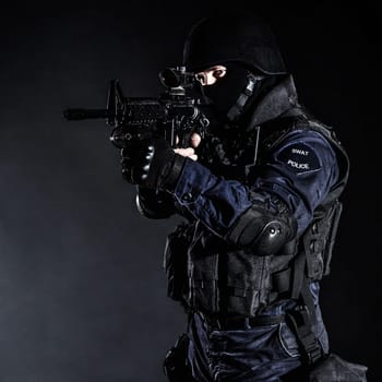 Special weapons and tactics (SWAT) team officer on black background