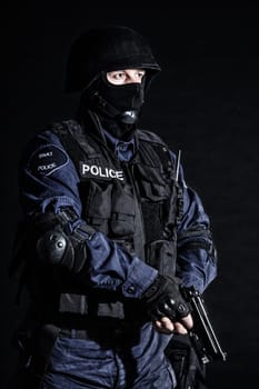 Special weapons and tactics (SWAT) team officer on black background