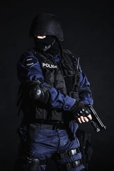 Special weapons and tactics (SWAT) team officer on black background
