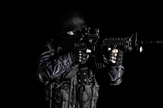 Special weapons and tactics (SWAT) team officer on black background