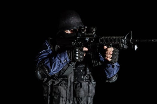 Special weapons and tactics (SWAT) team officer on black background