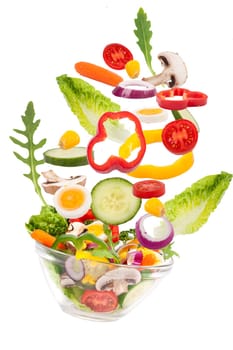 Salad falls into glass bowl