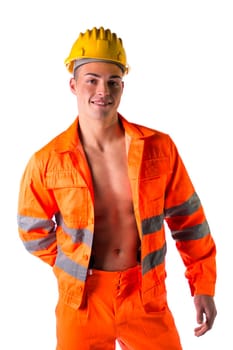 Handsome young construction worker with orange suit open on naked torso, smiling