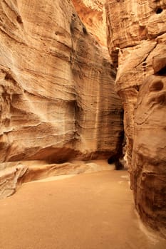 Rosy red walls of the Siq canyon, leading to the Treasury in Petra, Jordan.