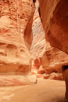 Rosy red walls of the Siq canyon, leading to the Treasury in Petra, Jordan.