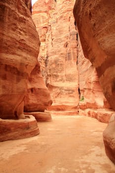Rosy red walls of the Siq canyon, leading to the Treasury in Petra, Jordan.