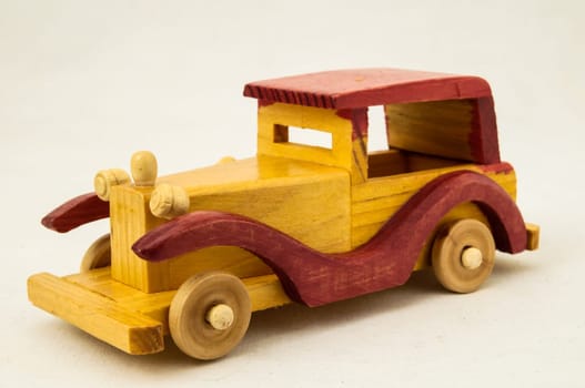 Wooden Toy Red and Yellow Car on a white Backgraund