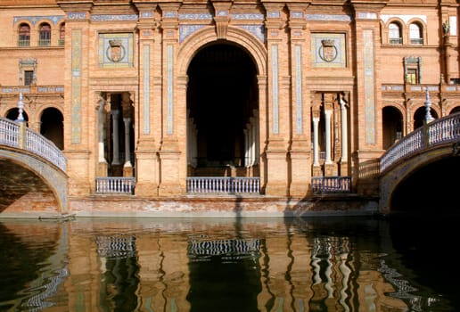 Building reflex in the  famous Plaza de Espana, Sevilla, Spain. Old city landmark.
