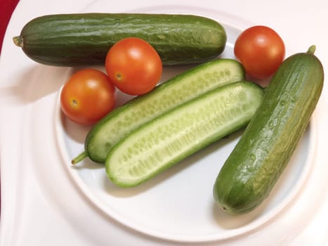Tomatoes and cucumbers on a white plate