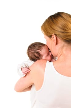 An adult woman with a white shirt tenderly holds an infant dressed in white in her arms,exposed against a white background.