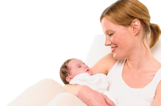 An adult woman with a white shirt tenderly holds an infant dressed in white in her arms,exposed against a white background.