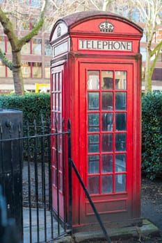 Old red telephone booth in Smithfield meat market in London, UK