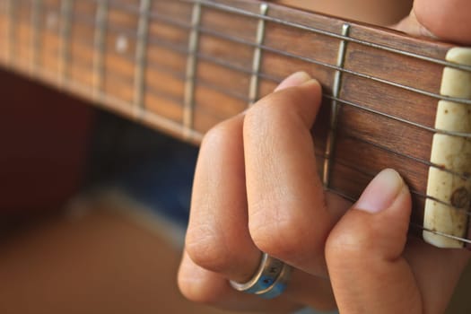 girl hand playing acoustic guitar, Close up of guitarist hand playing acoustic guitar
