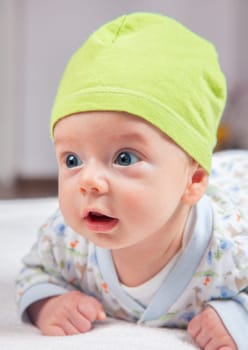 Portrait of 2 months baby boy doing tummy time at home.