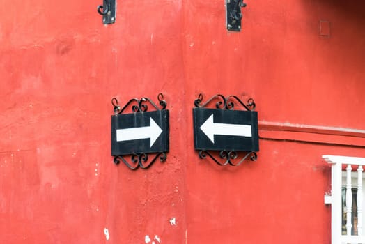 Two one way street signs on the corner of an old colonial historic building in Cartagena, Colombia
